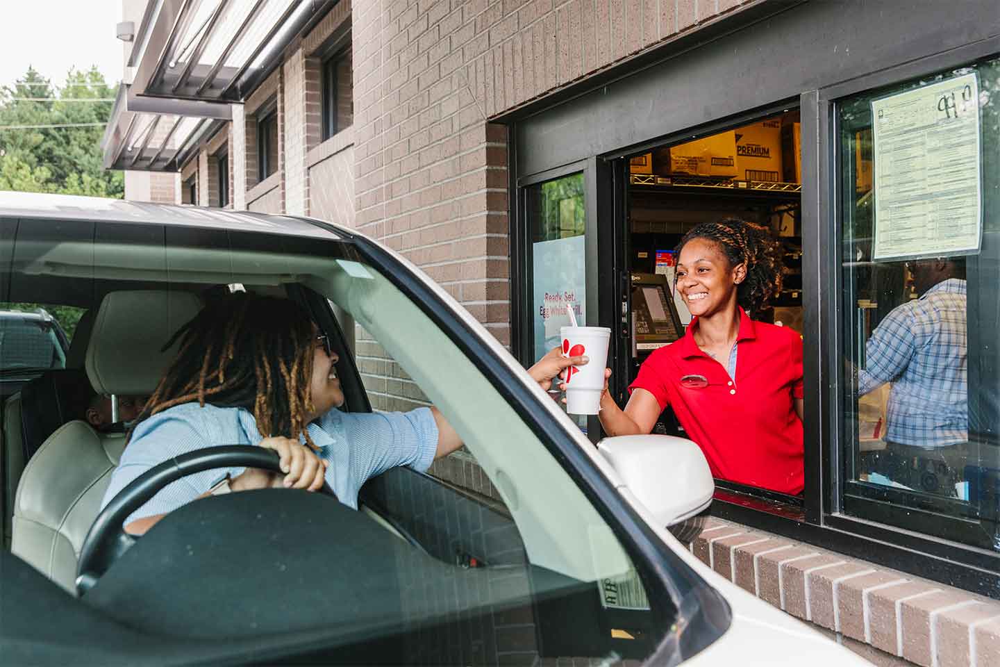 Chick-fil-A representative and customer interaction in the drive thru.